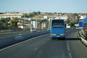 Tourist Bus on a Highway - Back View photo