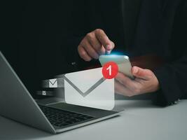 Businessman checking email on the phone screen. New email notification concept for business email communication and digital marketing. Inbox receives notification of electronic messages. photo