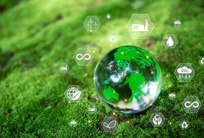 Crystal ball on moss in green forest. CO2 emission reduction concept, clean and friendly environment without carbon dioxide emissions. Planting trees to reduce CO2 emissions, photo