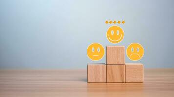 Human resources concept for leaders and team leaders. Business concept. Wooden blocks line up with smiling face icons. photo