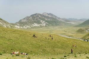 Bussi sul Tirino, Italy-august 10, 2021-People stroll and admire the mountains on Campo Imperatore in Abruzzo during a cloudy day photo