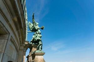 Berlin, Germany-august 9, 2022-view of the statues and landscape outside the dome of the berlin cathedral during a sunny day photo