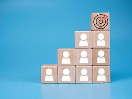 wooden block which prints a target icon and business symbol on white background. Business goals and objectives concept. business competition. business target concept. photo