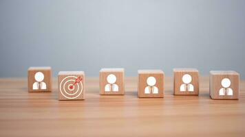 wooden block which prints a target icon and business symbol on white background. Business goals and objectives concept. business competition. business target concept. photo