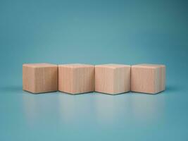 empty wooden blocks lined up on light blue background. Business concept,object. photo