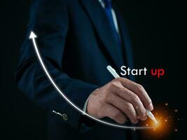 Businessman presses the pen at the starting point to start a business. Startup concept. Business concept. photo