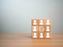 wooden block which prints a target icon and business symbol on white background. Business goals and objectives concept. business competition. business target concept. photo