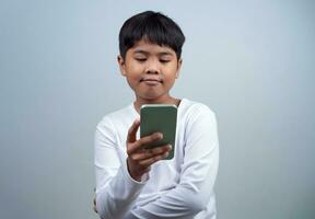 Social media and technology concepts. Boy's hands holding a smartphone and stylus pencil to use multimedia and social media to communicate. photo