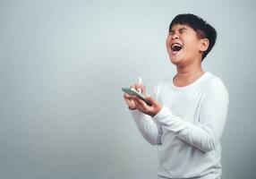 Social media and technology concepts. Boy's hands holding a smartphone and stylus pencil to use multimedia and social media to communicate. photo