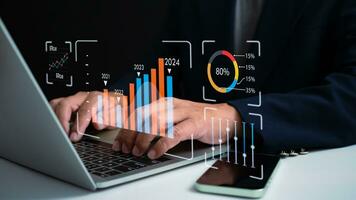 Business people use computers to analyze business and manage corporate data, business analytics with charts, metrics and KPIs to improve organizational performance, marketing, photo