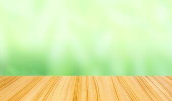 perspective wood table top on blur abstract green background photo
