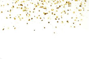 Gold confetti falling down in front of a white background photo