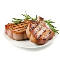 Grilled pork chops with rosemary sprigs perfectly isolated on a white background photo