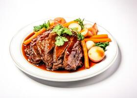 Braised beef brisket with vegetable garnish isolated on a white background photo