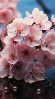 Pastel pink cherry blossoms bloom in a spring breeze. Vertical Mobile Wallpaper AI Generated photo