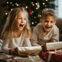 Excited children opening their presents on Christmas morning photo