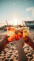 Friends cheering with cocktails on the beach photo