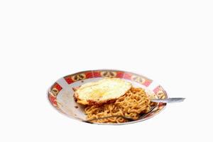 fried noodles with omelet on white background photo