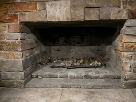 a vertical shot of a wooden fireplace with a white stone wall in the middle of a house photo