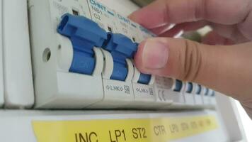 Bekasi, Indonesia on July 7 2023. A hand is turning on a switch on a home electrical Circuit Breaker Panel. video