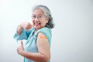 Asian elderly woman smiling happily Received immunization against coronavirus . White background. Copy space photo