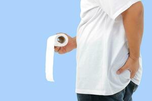 fat man wearing white shirt He had a stomachache, carrying toilet paper to go to the toilet. blue background. Clipping Path photo