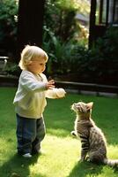 A toddler is happily playing with a kitten photo