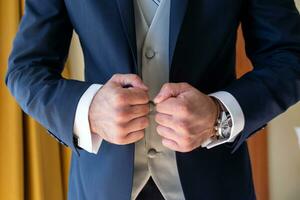 groom getting ready for his wedding. Detail of your watch photo