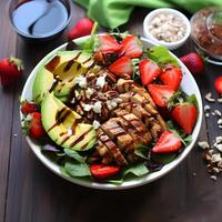 A refreshing summer salad with mixed greens strawberries avocado and grilled chicken photo