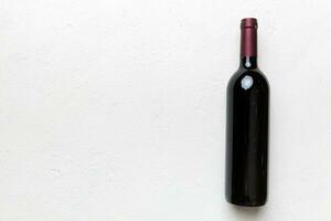 One Bottle of red wine on colored table. Flat lay, top view wth copy space photo