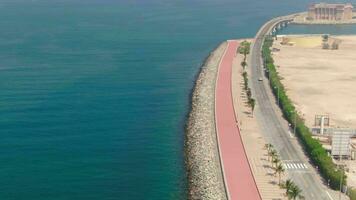 A drone flies over a road bridge over the sea in the United Arab Emirates. Aerial video