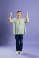 Gangang middle-aged Asian female portrait posing on purple background photo