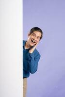 portrait of middle aged asian business man posing on purple background photo