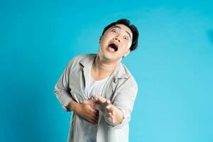 Image of Asian man having health problems, isolated on blue background photo