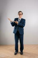 Portrait of an elderly Asian businessman, posing on a blue background photo