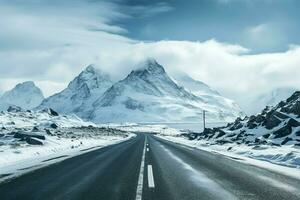 Empty road in the middle of snowy mountain range AI Generated photo