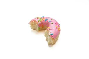 Edited photo. Messy strawberry doughnut isolated on white background. photo