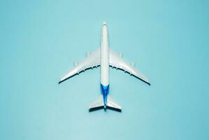 A plane miniature and isolated on blue background, after some edits. photo