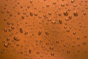 Ice Cold Water Drops on Orange Glass Abstract Background photo