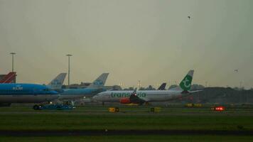 AMSTERDAM, THE NETHERLANDS JULY 27, 2017 - Boeing 737 Transavia taxiing and Boeing 737 KLM Royal Dutch Airlines PH BCA towing at early morning, Shiphol Airport, Amsterdam, Holland video
