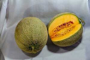 Cantaloupe sliced and placed on white cloth. photo