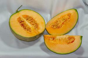 Cantaloupe sliced and placed on white cloth. photo