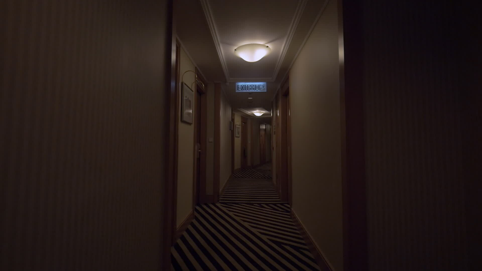 Clip of going along the hotel corridor to lighted exit sign Hong Kong, China 29352706 Stock
