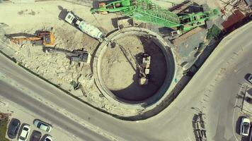 Concrete mixer and concrete pump working in subway tunnel shaft construction. aerial slow motion video