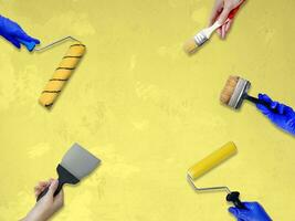 construction concept hands with all of tools supplies for home construction builder and copy space isolated on yellow background photo