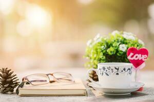 primer plano de cuaderno vacío, gafas y taza de café sobre fondo de piso de mármol. concepto de amor con escritorio de corazón, día de san valentín. foto