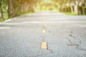 Close-up of Rural roads Beside with of Abstract blur green nature forest with evening sunset background. photo