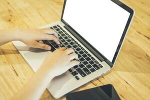 Close-up of business female working with laptop and smartphone in coffee shop like the background photo