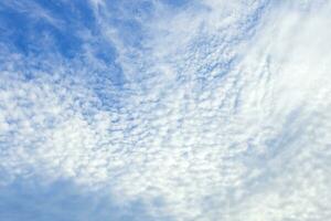 Autumn blue sky background texture with white spindrift very clouds. photo