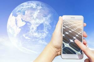 Use smartphone blurred images touch of solar panels in earth blue sky background texture with white clouds,Alternative energy concept,Elements of this earth image furnished by NASA. photo